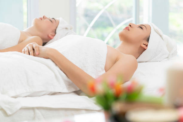 istock Relaxed young woman lying on spa bed for massage. 999852282