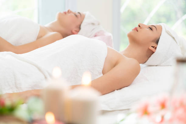 istock Relaxed young woman lying on spa bed for massage. 999852288
