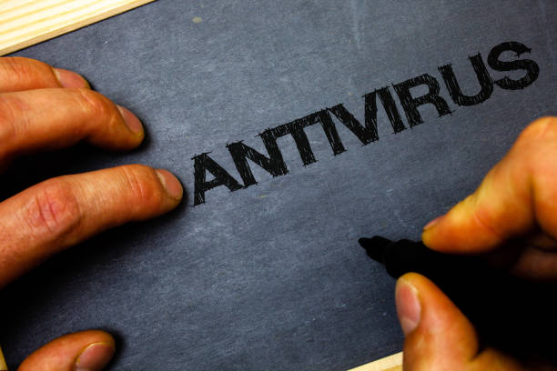 istock Word writing text Antivirus. Business concept for Safekeeping Barrier Firewall Security Defense Protection Surety Man hold holding black marker markers notebook wood wooden background. 999852330