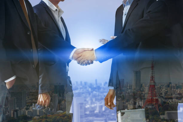 istock Double exposure Business People Handshake Meeting 999854760