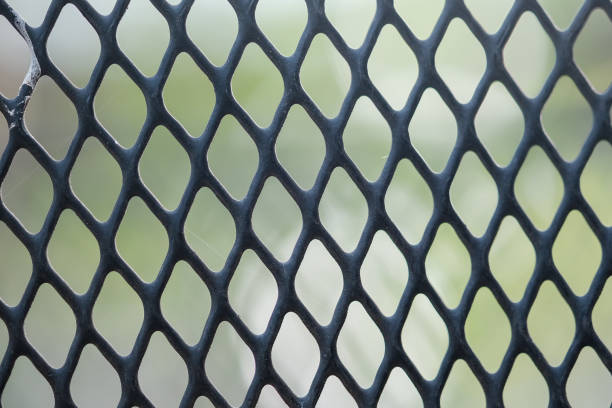 istock Black fence on green background 999855444