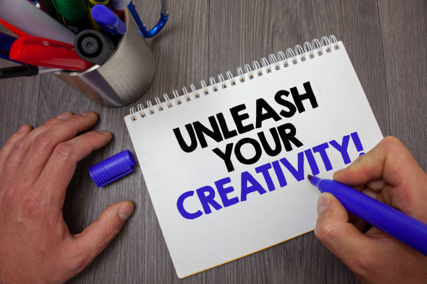 istock Text sign showing Unleash Your Creativity Call. Conceptual photo Develop Personal Intelligence Wittiness Wisdom Man hold holding blue marker notebook page markers table messages ideas. 999855566