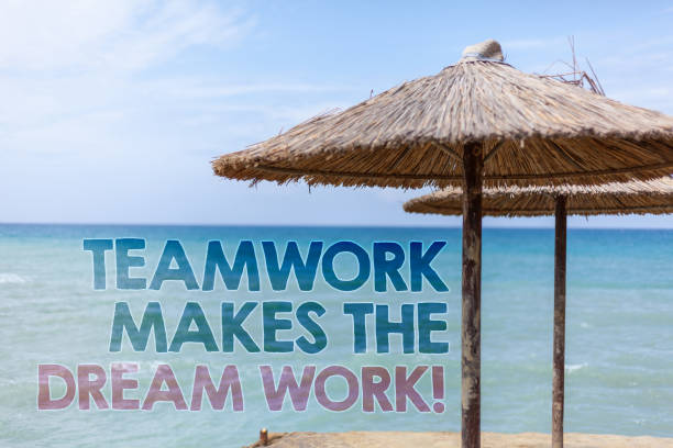 istock Word writing text Teamwork Makes The Dream Work Call. Business concept for Camaraderie helps achieve success Blue beach water Thatched Straw Umbrellas Message Ideas Thoughts Reflection. 999856248