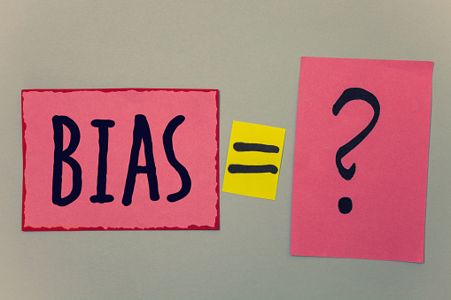 Conceptual hand writing showing Bias. Business photo text Unfair Subjective One-sidedness Preconception Inequality Bigotry Paper equal sign question marks beige background doubt message