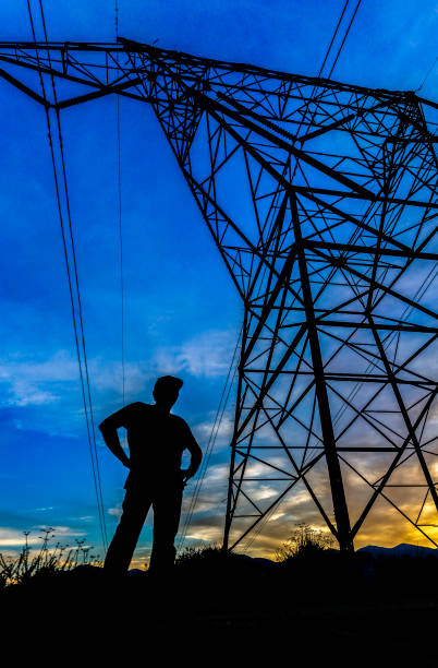 istock Man stands with authority near electrical tower 999859904