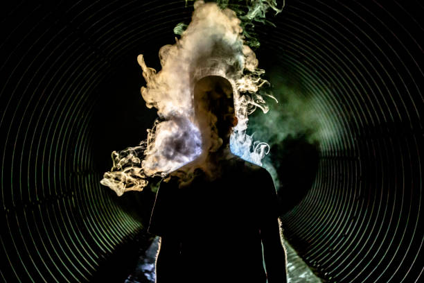 istock Man with smoke lifting from body in a tunnel 999859926