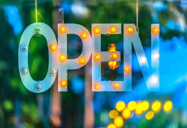 istock Open sign with out of focus light bulbs 999859952