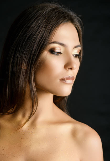 istock Young woman with golden makeup. 999865336