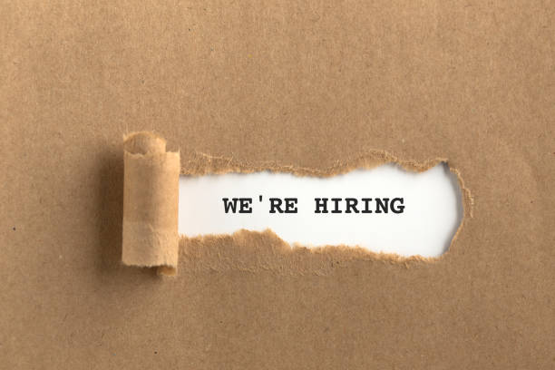 istock The text WE'RE HIRING behind torn brown paper 999865848