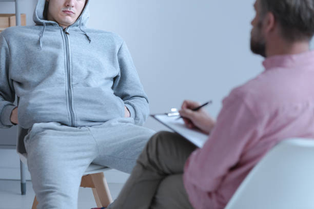 Juvenile offender talking to his curator during a meeting Juvenile offender talking to his curator during a meeting criminal stock pictures, royalty-free photos & images