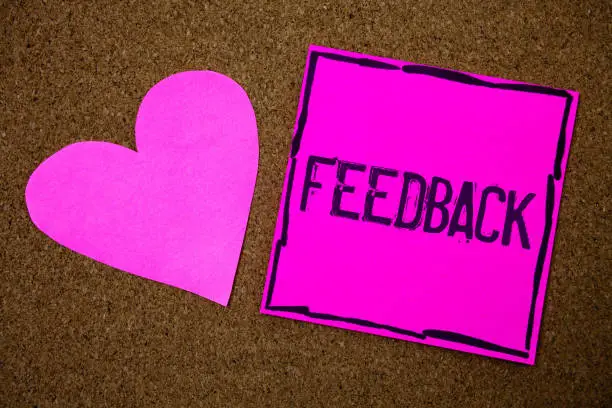 Photo of Handwriting text writing Feedback. Concept meaning Customer Review Opinion Reaction Evaluation Give a response back Cork background pink paper papers ideas messages heart love lovely inspire.