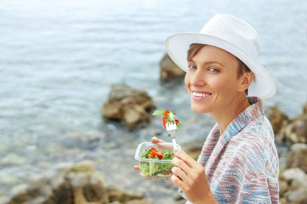 istock Woman eatins salad 999876350