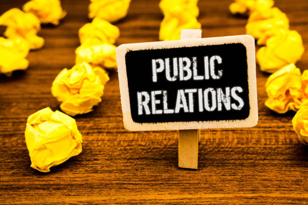 istock Handwriting text writing Public Relations. Concept meaning Communication Media People Information Publicity Social White text black paint wooden board clip desk yellow paper notes warning. 999876714