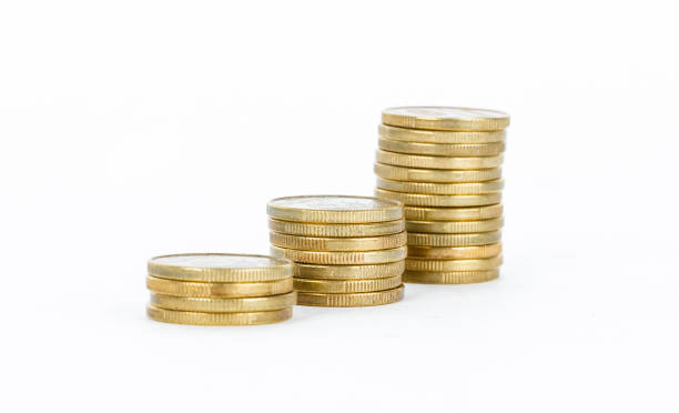 istock Columns of gold coins on white background 999879890