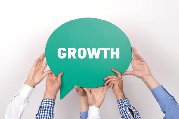 istock Group of people holding the GROWTH written speech bubble 999880024