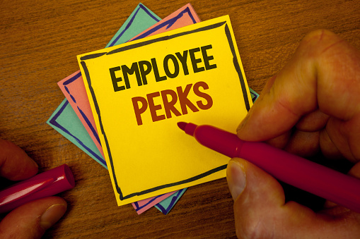 Conceptual hand writing showing Employee Perks. Business photo text Worker Benefits Bonuses Compensation Rewards Health Insurance Text colorful paper notes hand red marker open cap desk letter