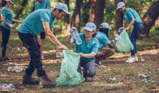 istock Group of volunteers picking up trash 999883382
