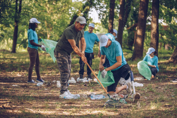 istock Volunteers cleaning up garbage in public park 999884320