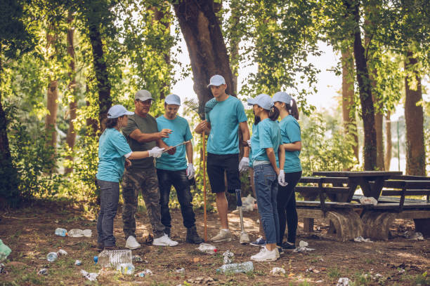 istock Volunteers picking up trash in public park 999886862