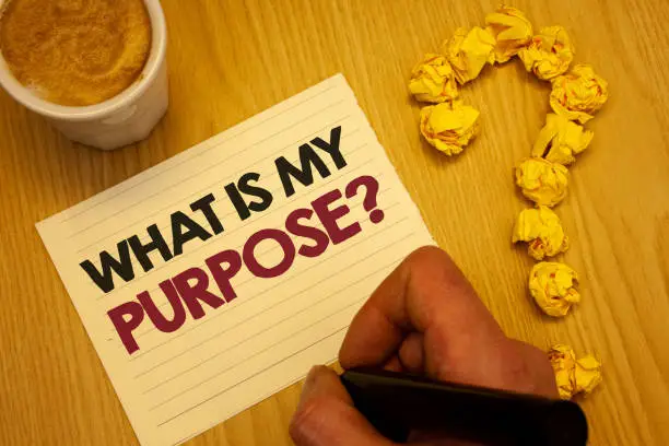 Photo of Conceptual hand writing showing What Is My Purpose Question. Business photo showcasing Direction Importance Discernment Reflection Wooden desktop hand hold marker page coffee question mark.