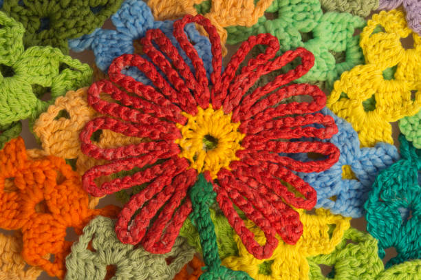 istock Handmade knitted colorful flower wool texture background 999890078