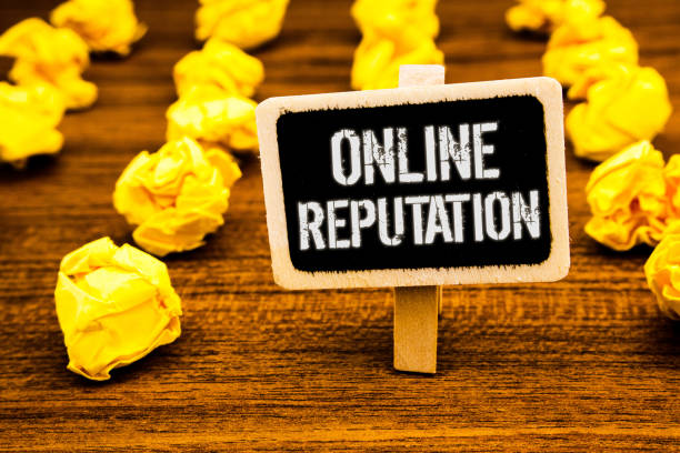 istock Handwriting text writing Online Reputation. Concept meaning Reliability Ranking Review Evaluation Satisfaction Quality White text black paint wooden board clip desk yellow paper notes warning. 999890232