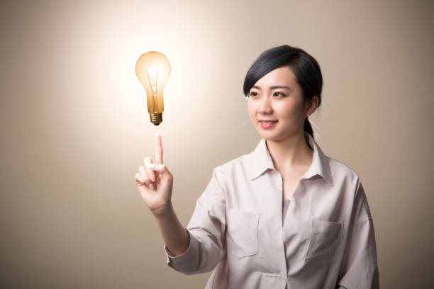 istock Young woman having a light bulb above finger 999892884