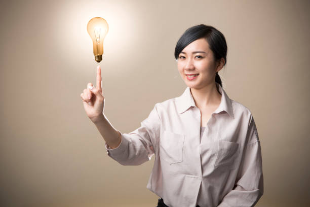 istock Young woman having a light bulb above finger 999892898