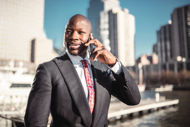istock Smiling businessman using phone on the go 999893166