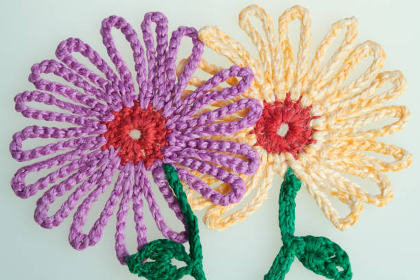 istock Handmade wool knitted flower colorful texture background 999896080