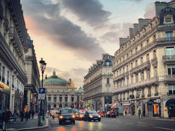 Avenue de l'Opera in Paris with Opera Garnier building, France Paris, France - April 28, 2018: Avenue de l'Opera in Paris with view on Opera Garnier building  and cars on the street. place de lopera stock pictures, royalty-free photos & images