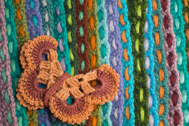 istock Handmade buterfly wool knitted colorful texture background 999912010