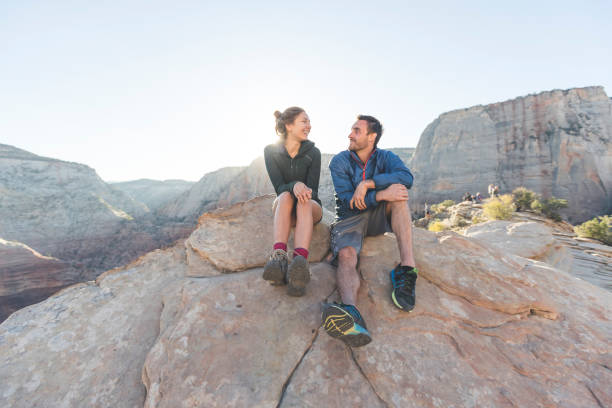 istock Young couple sitting together on a cliff 999913306