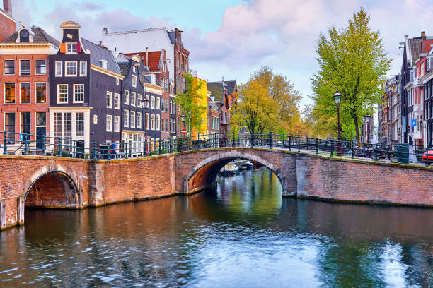 istock Bridge over channel in Amsterdam Netherlands houses river Amstel 999930830