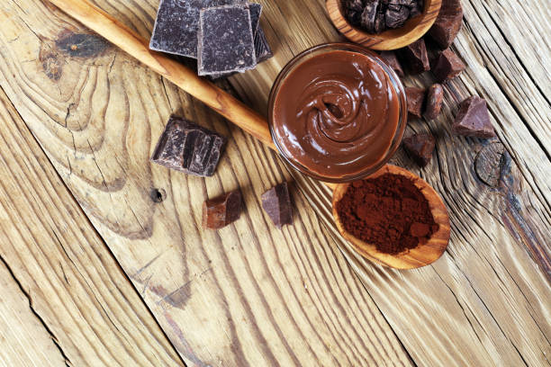 istock Melting chocolate  or melted chocolate with a chocolate swirl. Many stack and chips with powder. 999934664