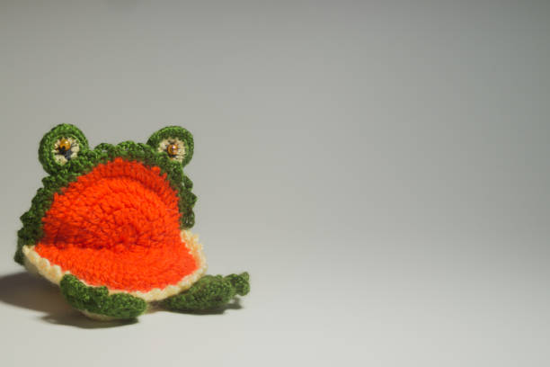 istock Handmade knitted toy frog isolated on white background 999935374