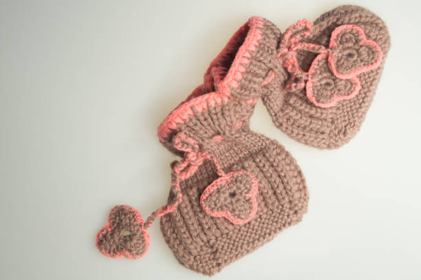 istock Handmade knitting baby booties isolated on white 999939108