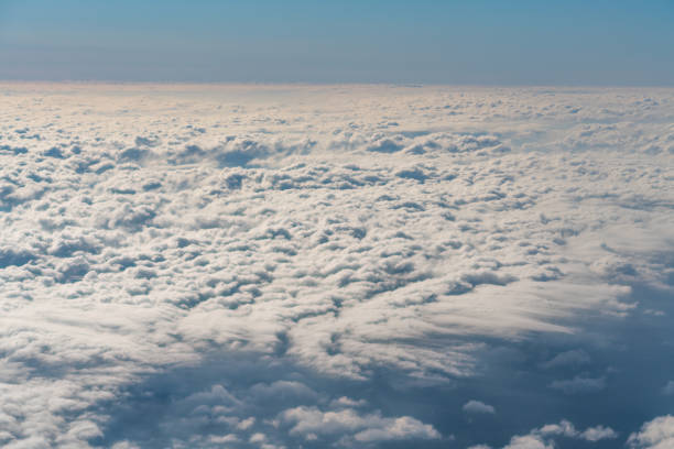 istock cloud in the sky, Looking to the window in the airplane. 999940394