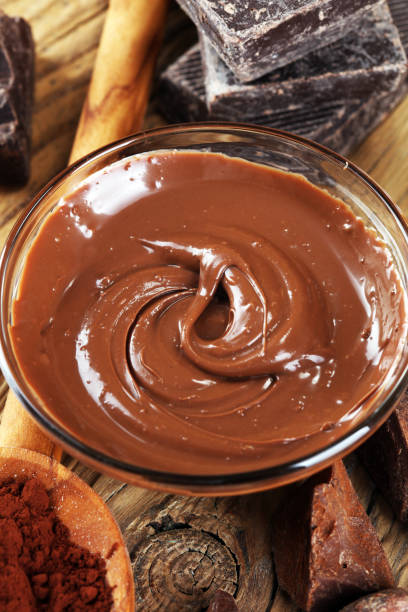 istock Melting chocolate  or melted chocolate with a chocolate swirl. Many stack and chips with powder. 999940642