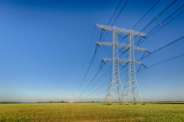 High voltage pylons against a blue sky in dramatized colors
