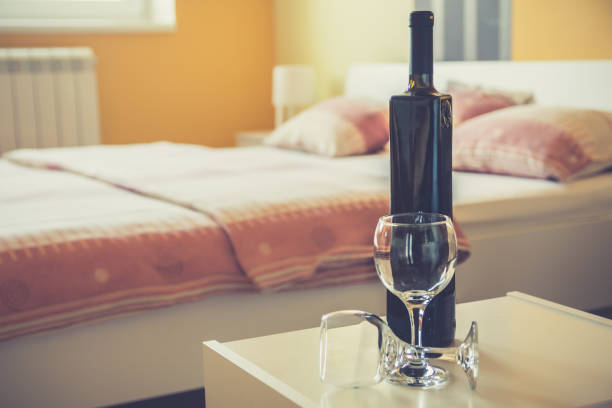 istock Wine bottle and two glasses in bedroom 999951522