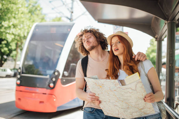 istock Young couple hugging and looking for the bus 999951884