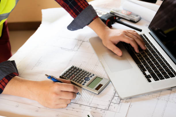istock hand of engineer working on blueprints in the office. 999952464