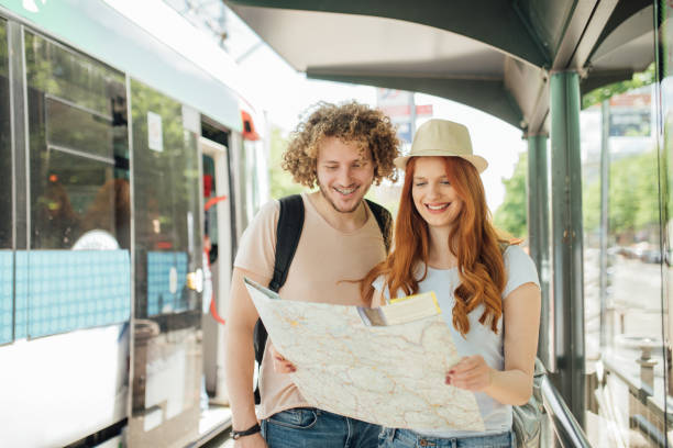 istock Young couple reading the map on a bus station 999956262