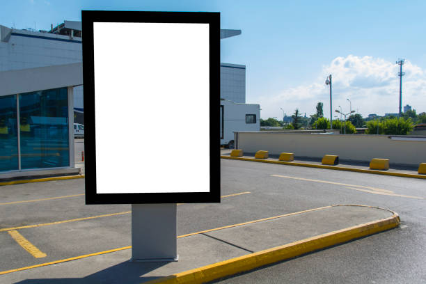 istock Blank white mock up of vertical light box billboard at car park 999959036