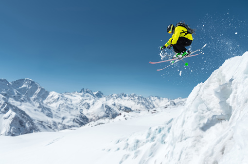 Aspen, Colorado, USA- February 11, 2023: Skier getting big air on a jump at Buttermilk ski resort, Aspen, Colorado.