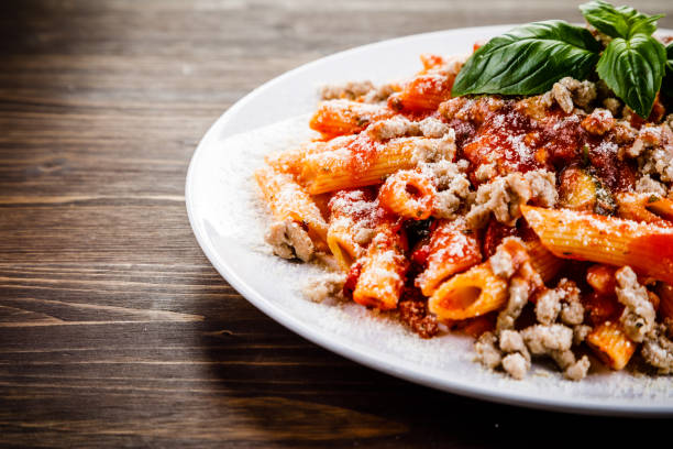 istock Penne with tomato sauce and pork 999962820