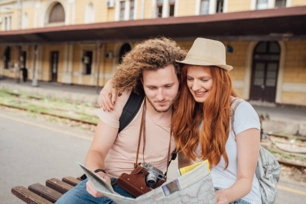 istock Redhead woman looking at the map and hugging her boyfriend 999975362