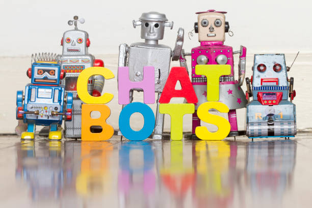 istock the word  CHAT BOTS with retro robots on a wooden floor 999978708