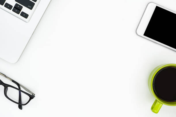istock White minimal office desk. Top view with copy space, flat lay. 999980848